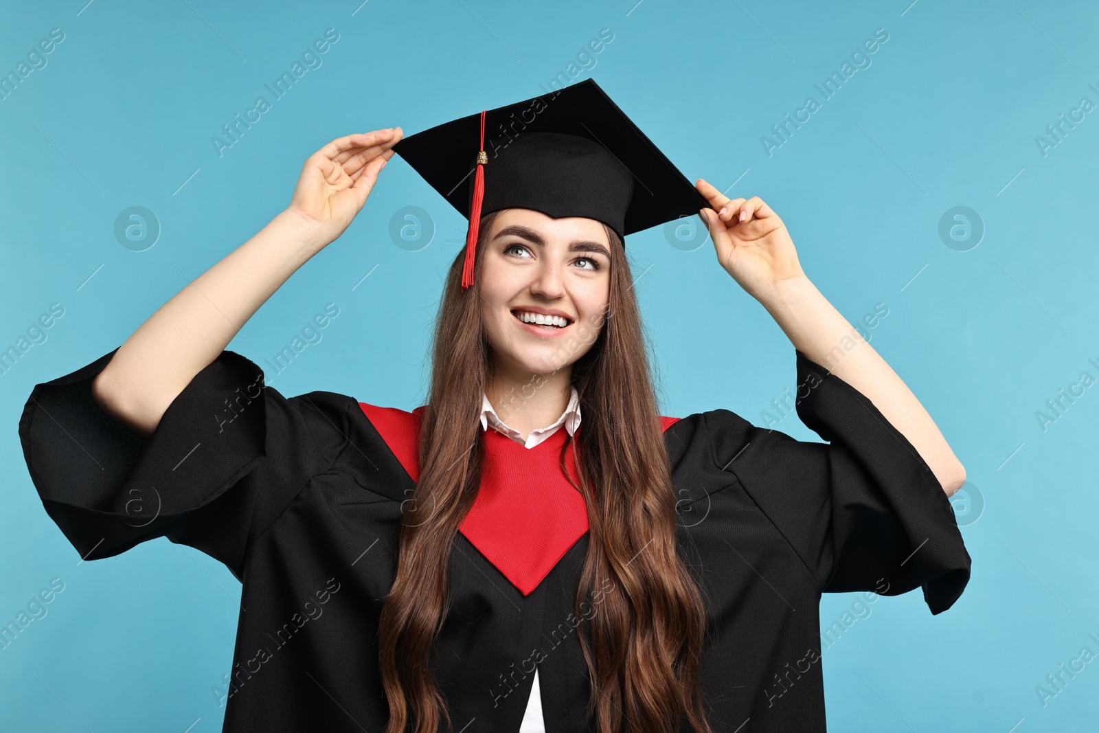 Photo of Happy student after graduation on light blue background