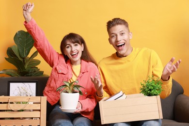 Happy couple with different stuff in new apartment. Housewarming party