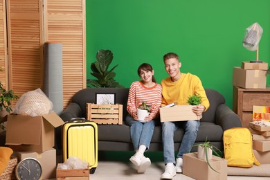 Photo of Happy couple with different stuff in new apartment. Housewarming party