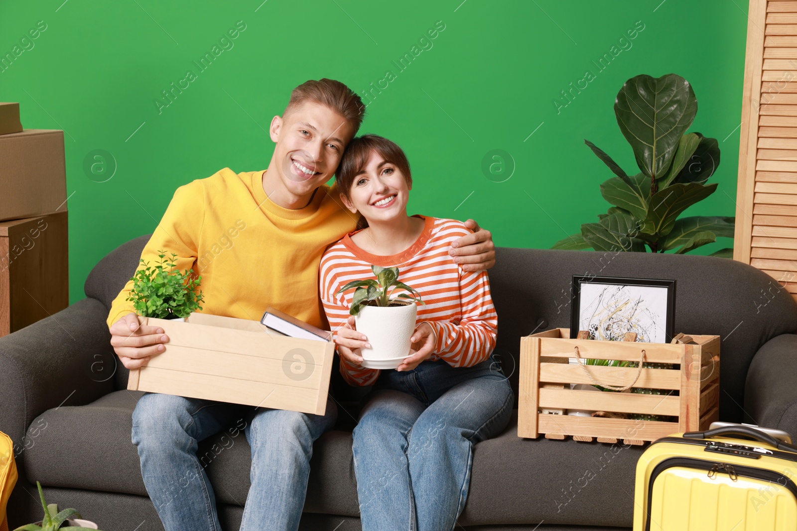 Photo of Happy couple with different stuff in new apartment. Housewarming party