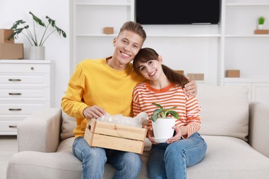 Happy couple with different stuff in new apartment. Housewarming party