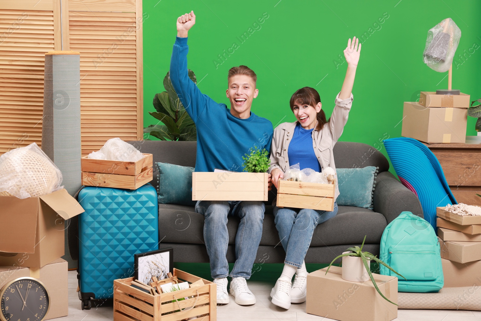 Photo of Happy couple with different stuff in new apartment. Housewarming party