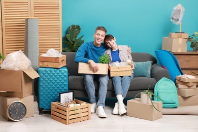 Photo of Happy couple with different stuff in new apartment. Housewarming party