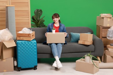 Photo of Happy woman with different stuff in new apartment. Housewarming party