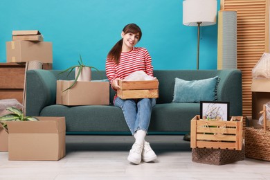 Photo of Happy woman with moving boxes in new apartment. Housewarming party