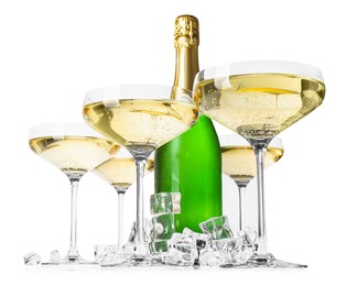 Photo of Bottle and glasses of champagne with ice cubes isolated on white, low angle view