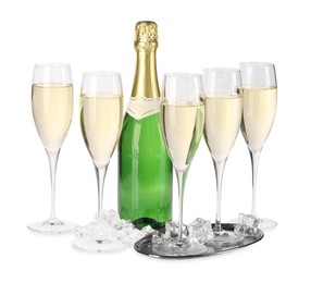 Photo of Bottle and glasses of champagne with ice cubes isolated on white