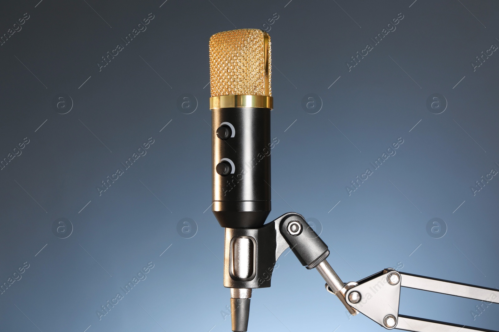 Photo of Stand with microphone on dark background. Sound recording and reinforcement