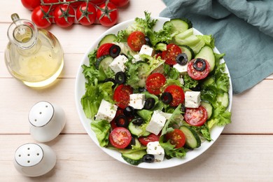 Photo of Delicious salad with feta cheese on white wooden table, flat lay