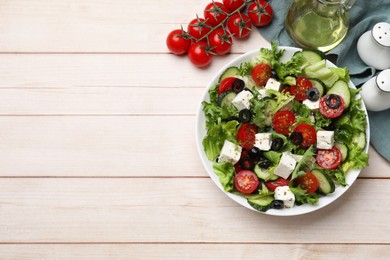 Photo of Delicious salad with feta cheese on white wooden table, flat lay. Space for text