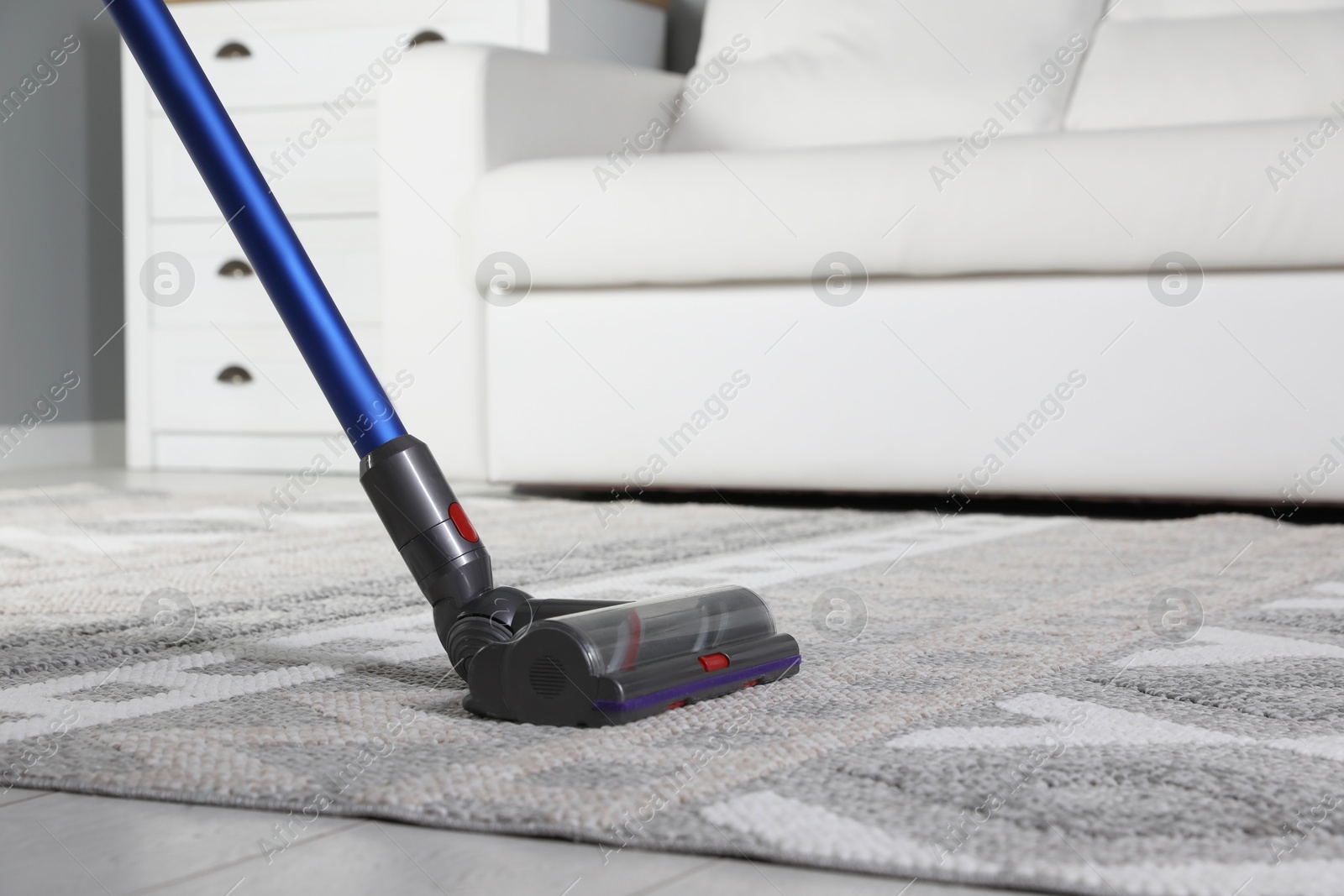 Photo of Cleaning with wireless vacuum cleaner at home, closeup. Space for text