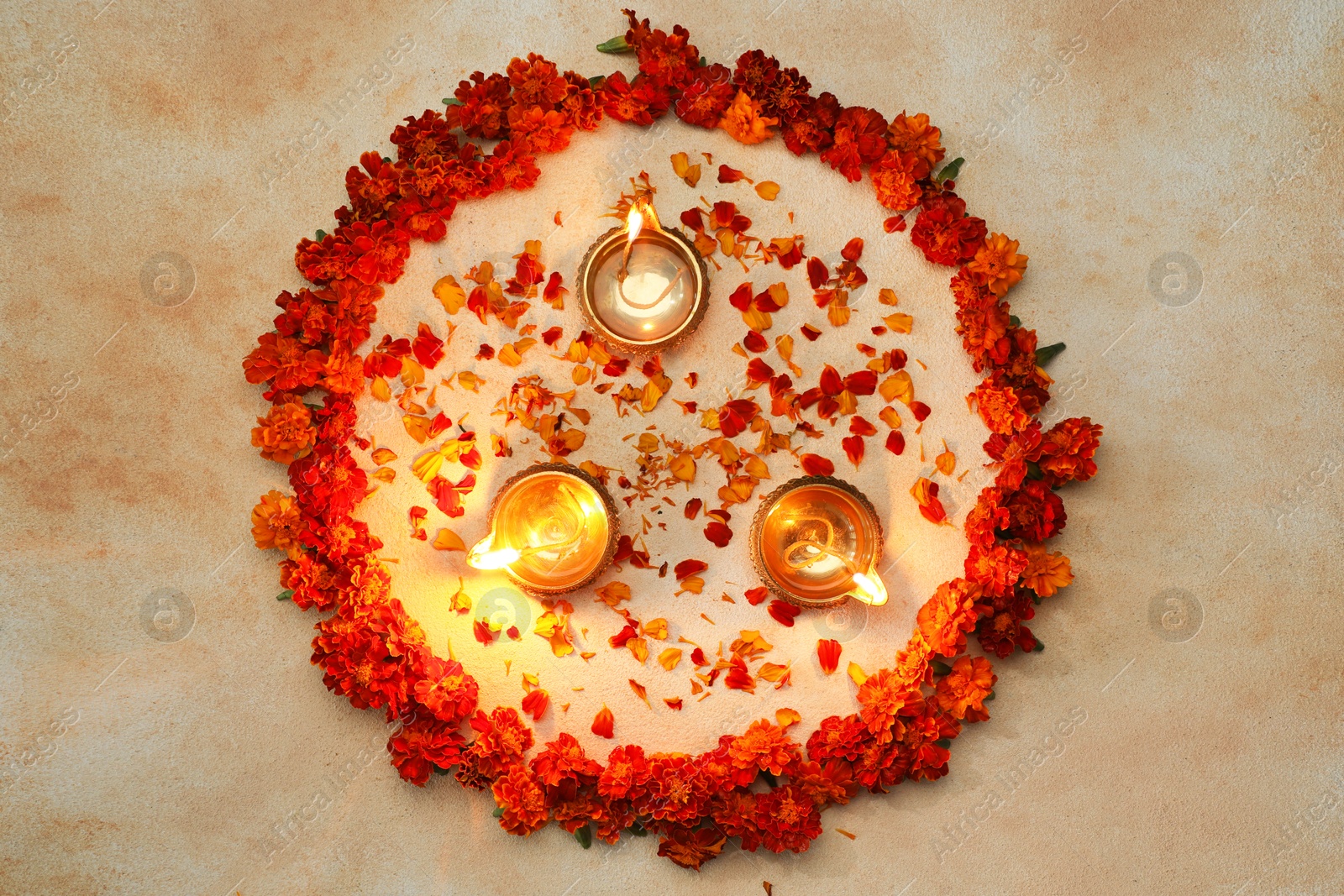 Photo of Diwali celebration. Diya lamps and beautiful flowers on light background, top view