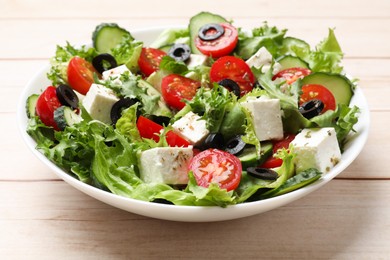 Photo of Delicious salad with feta cheese on white wooden table, closeup