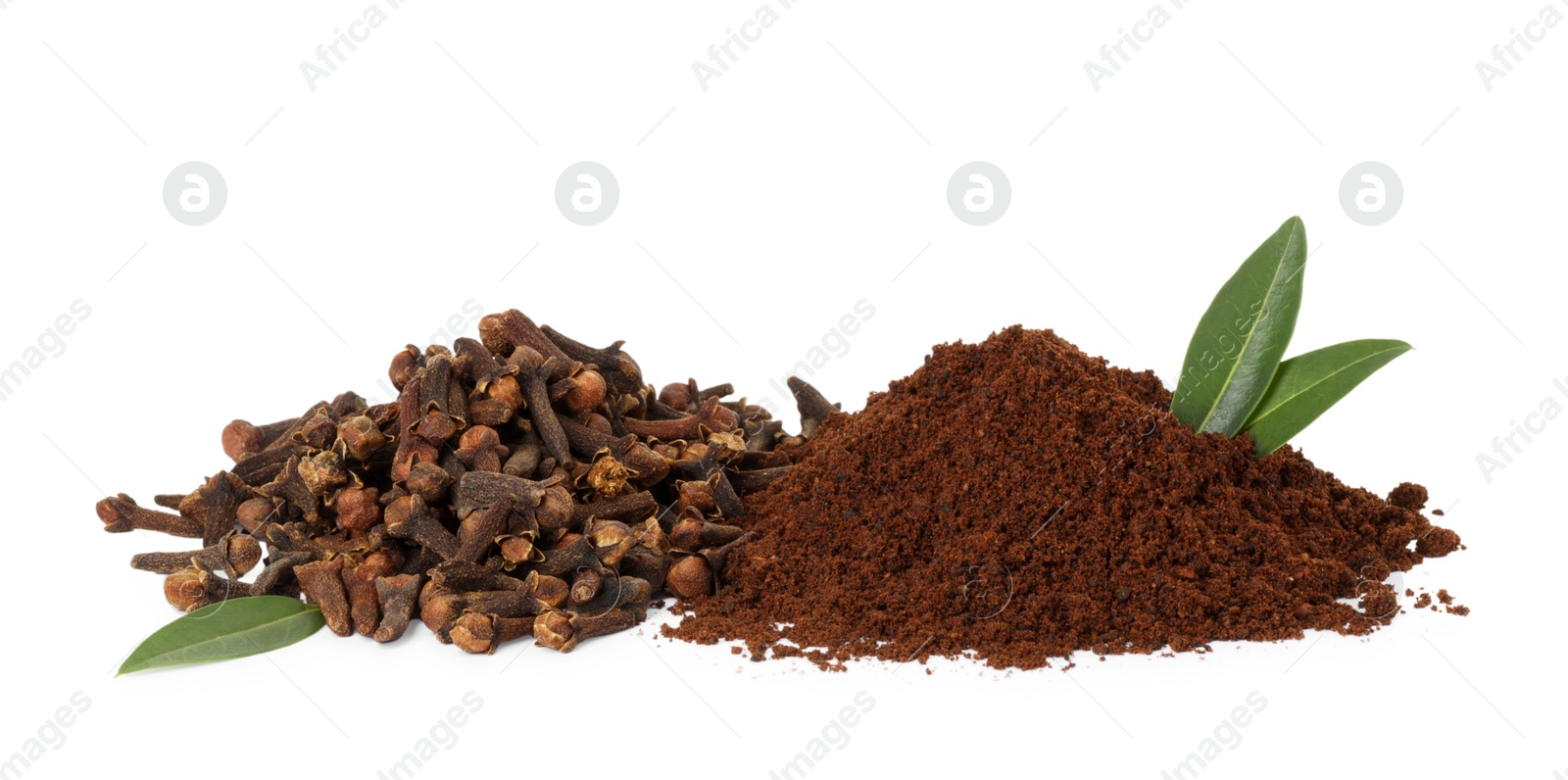 Photo of Pile of clove powder, dried buds and green leaves on white background. Aromatic spice