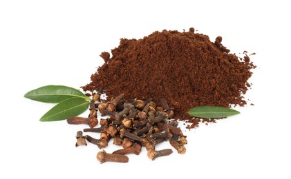 Photo of Pile of clove powder, dried buds and green leaves on white background. Aromatic spice