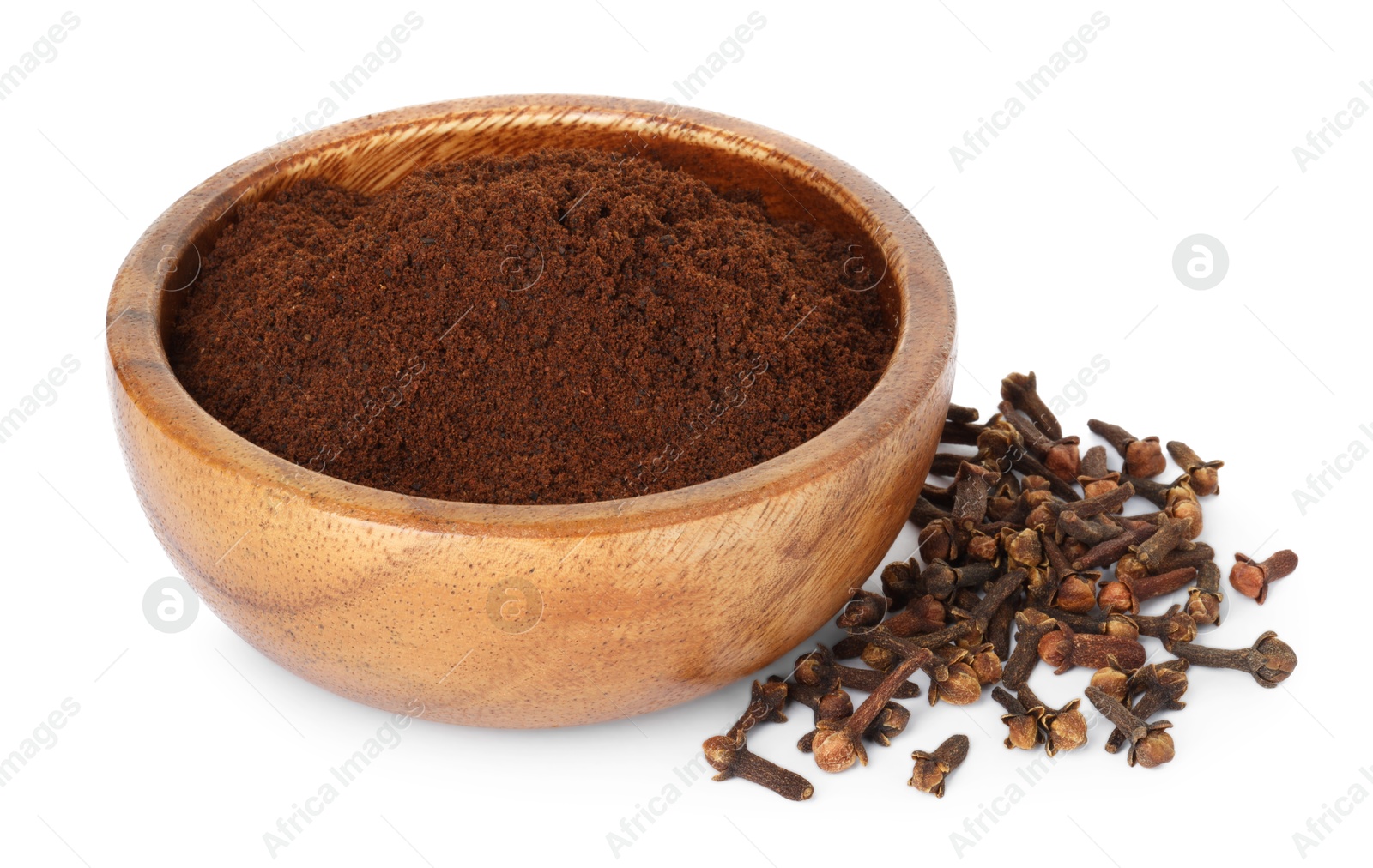 Photo of Clove powder in wooden bowl and dried buds on white background. Aromatic spice