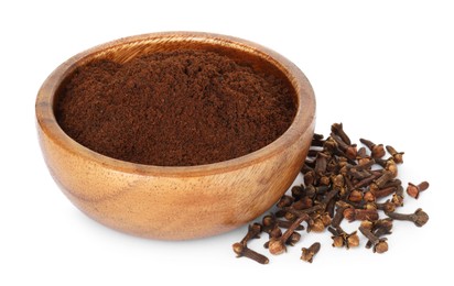 Clove powder in wooden bowl and dried buds on white background. Aromatic spice