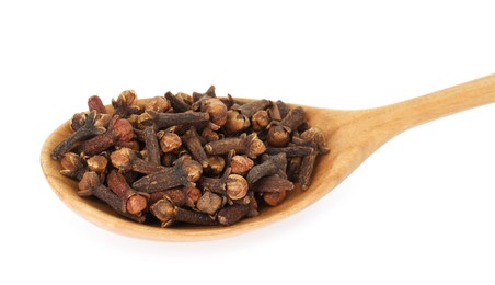 Dry clove buds in wooden spoon on white background. Aromatic spice