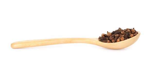 Photo of Dry clove buds in wooden spoon on white background. Aromatic spice