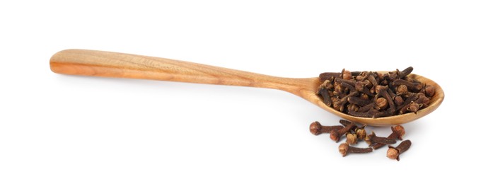 Dry clove buds in wooden spoon on white background. Aromatic spice