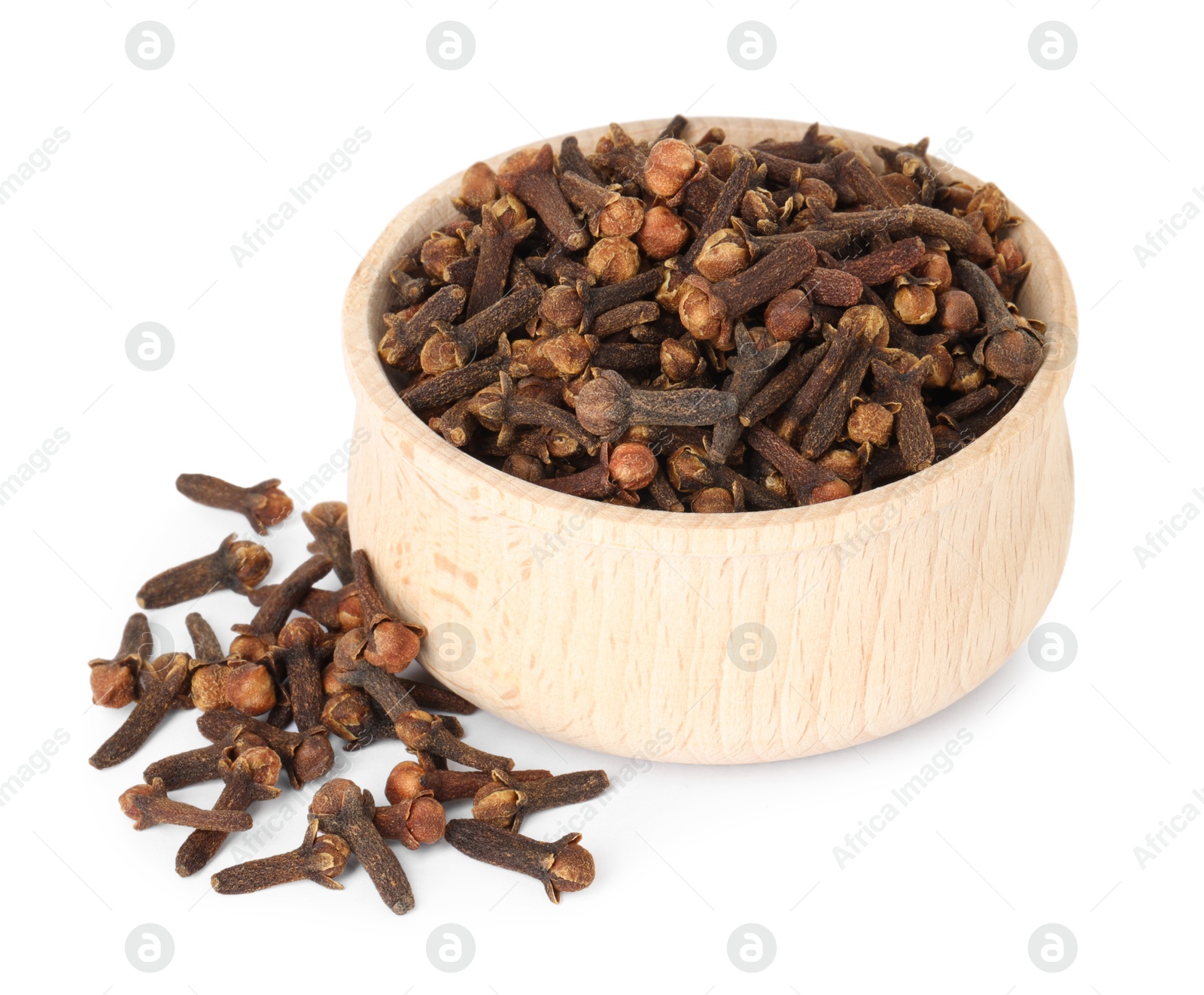 Photo of Dry clove buds in wooden bowl on white background. Aromatic spice