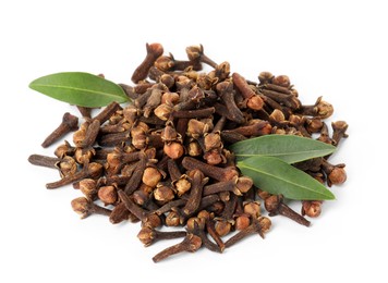 Pile of dry clove buds and green leaves on white background. Aromatic spice