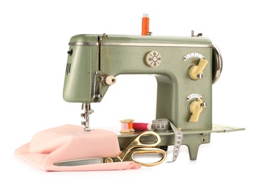 Photo of Sewing machine with pink fabric, measuring tape, scissors and spools of threads isolated on white