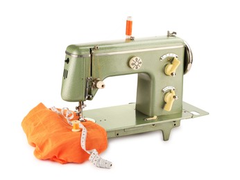 Photo of Sewing machine with orange fabric, measuring tape and spools of threads isolated on white