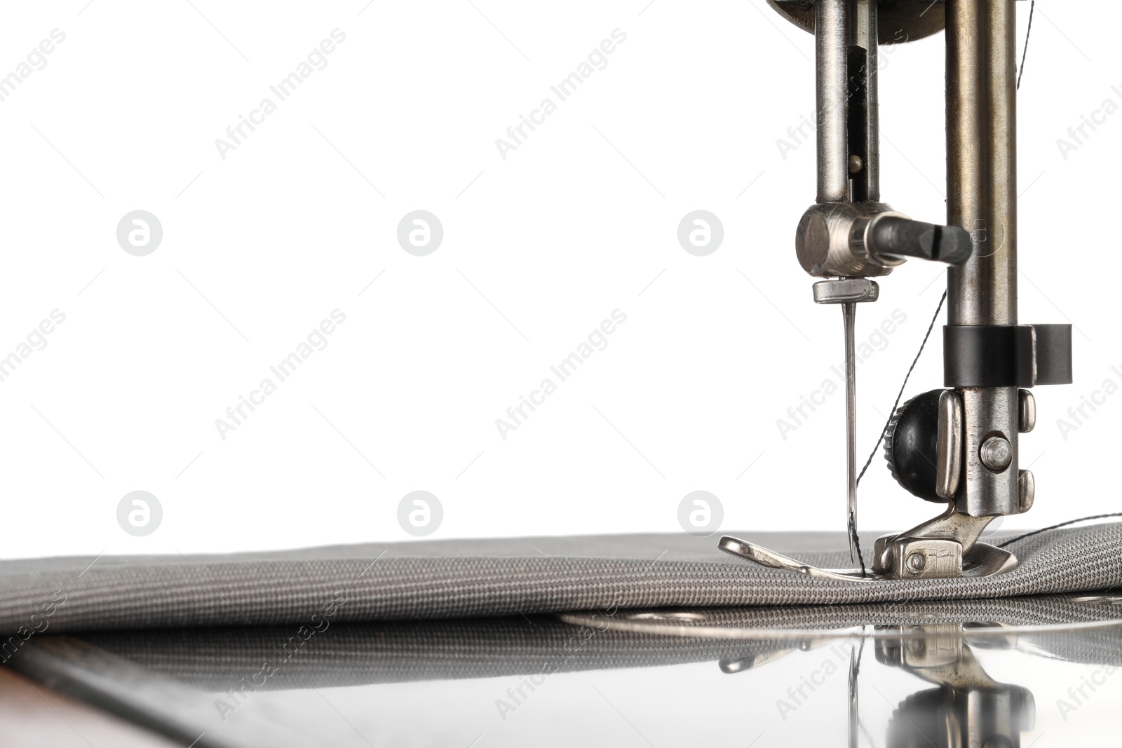 Photo of Sewing machine with grey fabric isolated on white