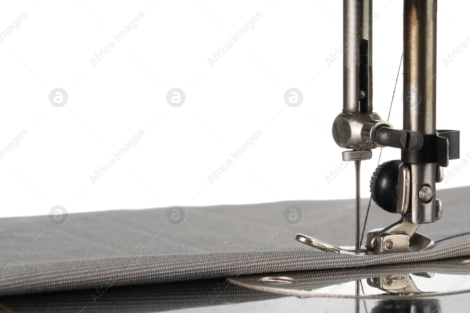 Photo of Sewing machine with grey fabric isolated on white