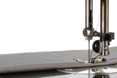 Photo of Sewing machine with grey fabric isolated on white