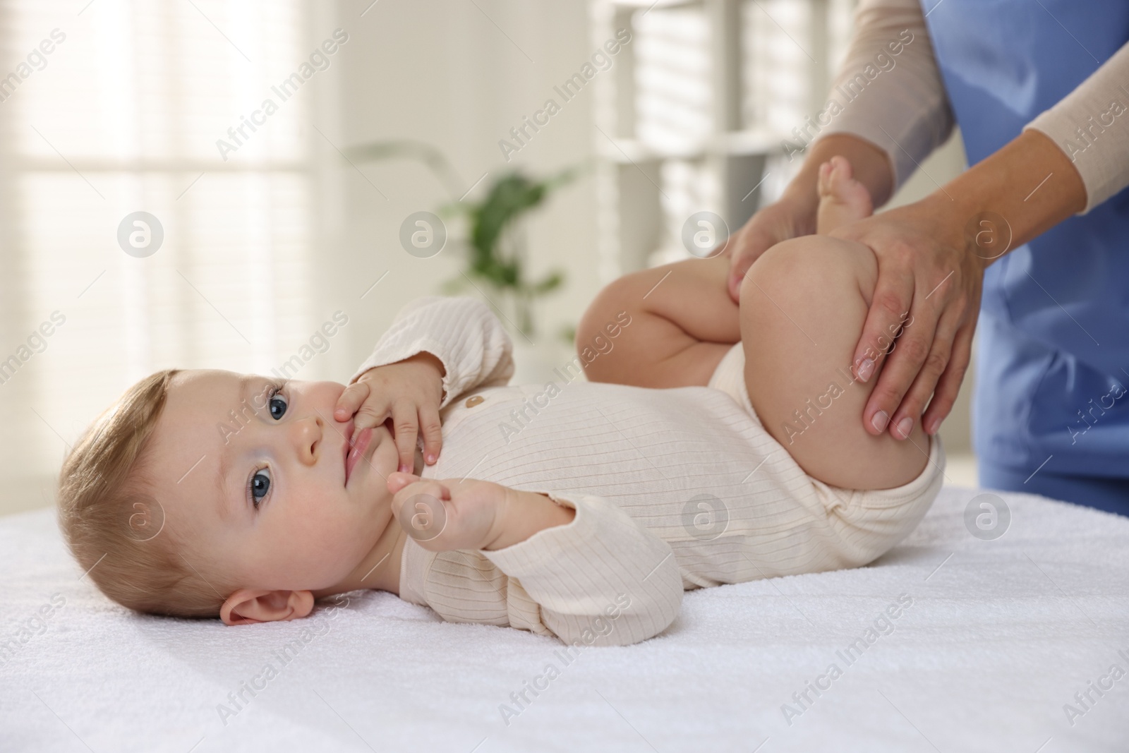 Photo of Pediatrician with little child in clinic, closeup. Checking baby's health