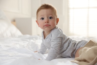 Cute little baby on bed at home