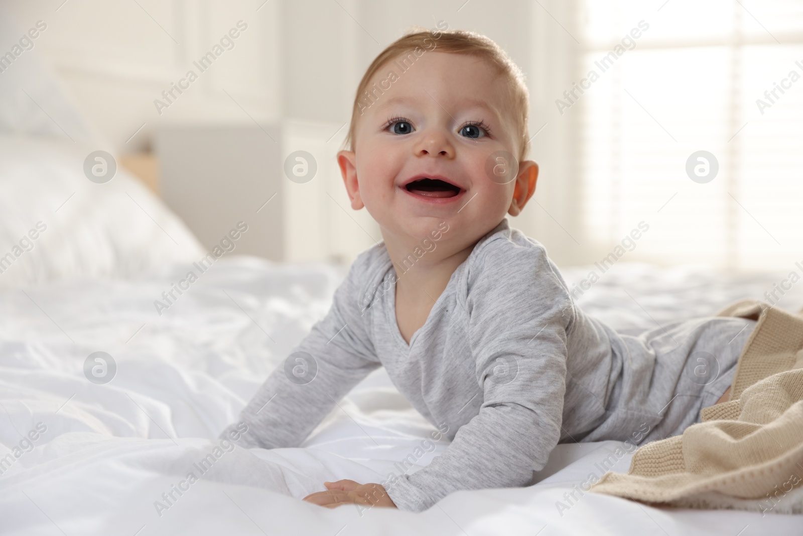 Photo of Cute little baby on bed at home