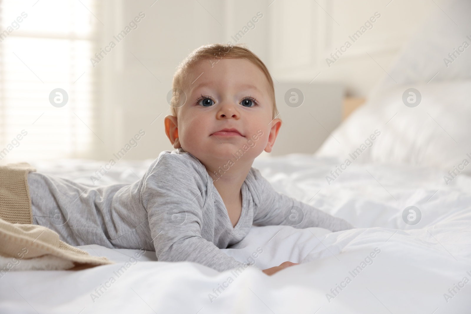 Photo of Cute little baby on bed at home