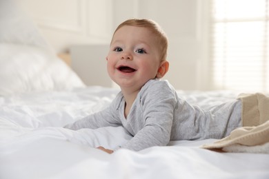 Photo of Cute little baby on bed at home