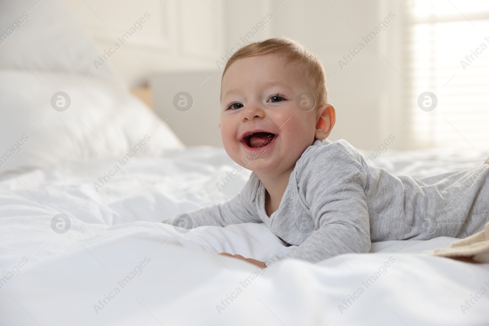 Photo of Cute little baby on bed at home