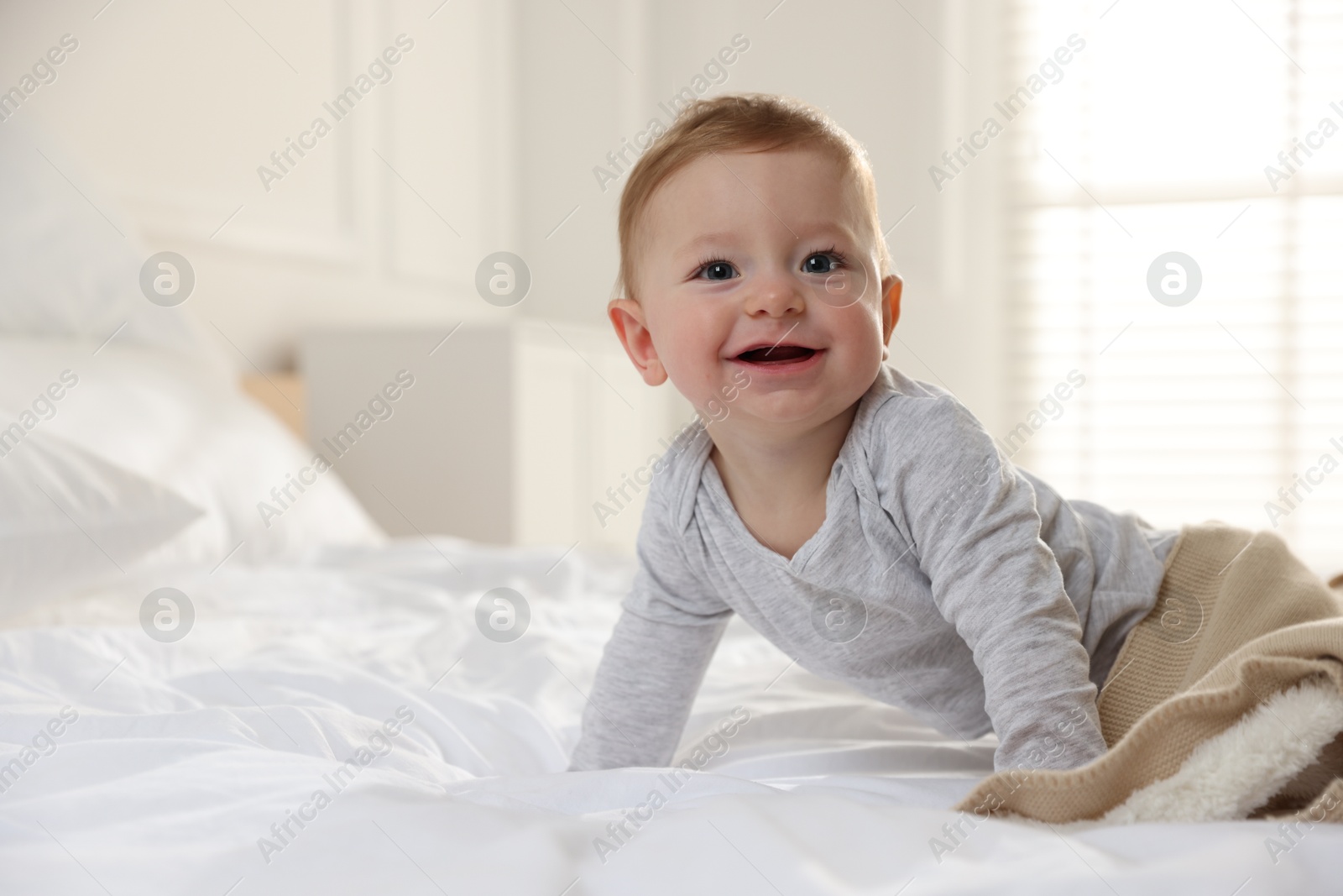 Photo of Cute little baby on bed at home