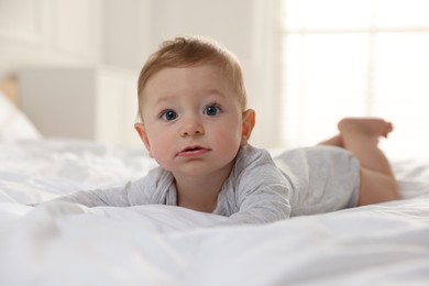 Cute little baby on bed at home