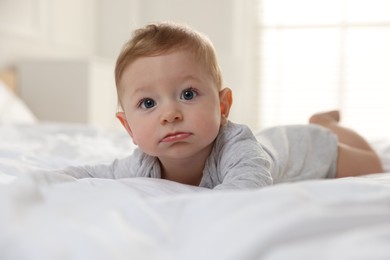 Cute little baby on bed at home