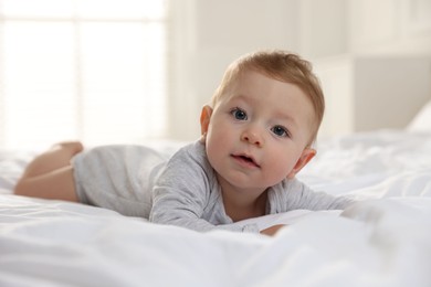 Cute little baby on bed at home