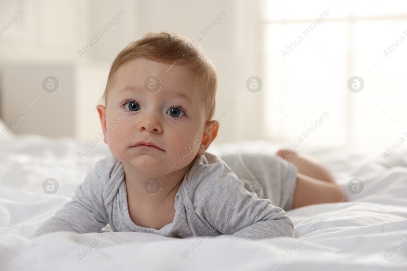 Photo of Cute little baby on bed at home