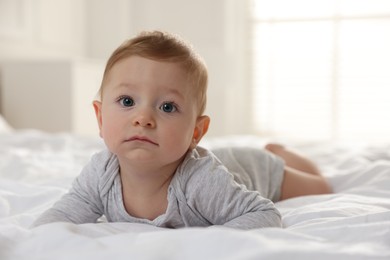 Photo of Cute little baby on bed at home