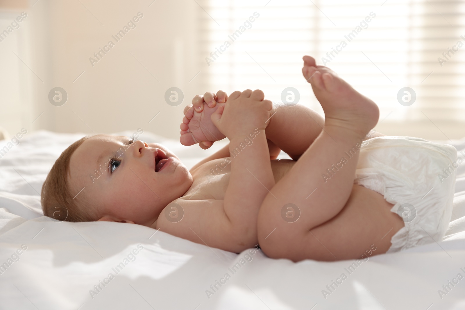 Photo of Cute little baby on bed at home