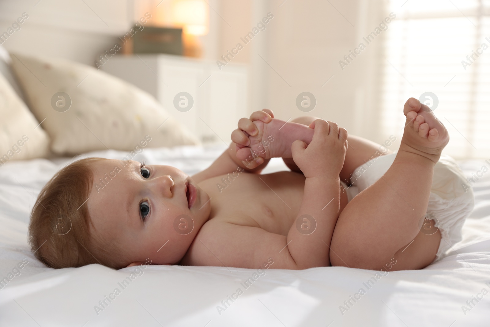 Photo of Cute little baby on bed at home