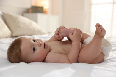 Cute little baby on bed at home