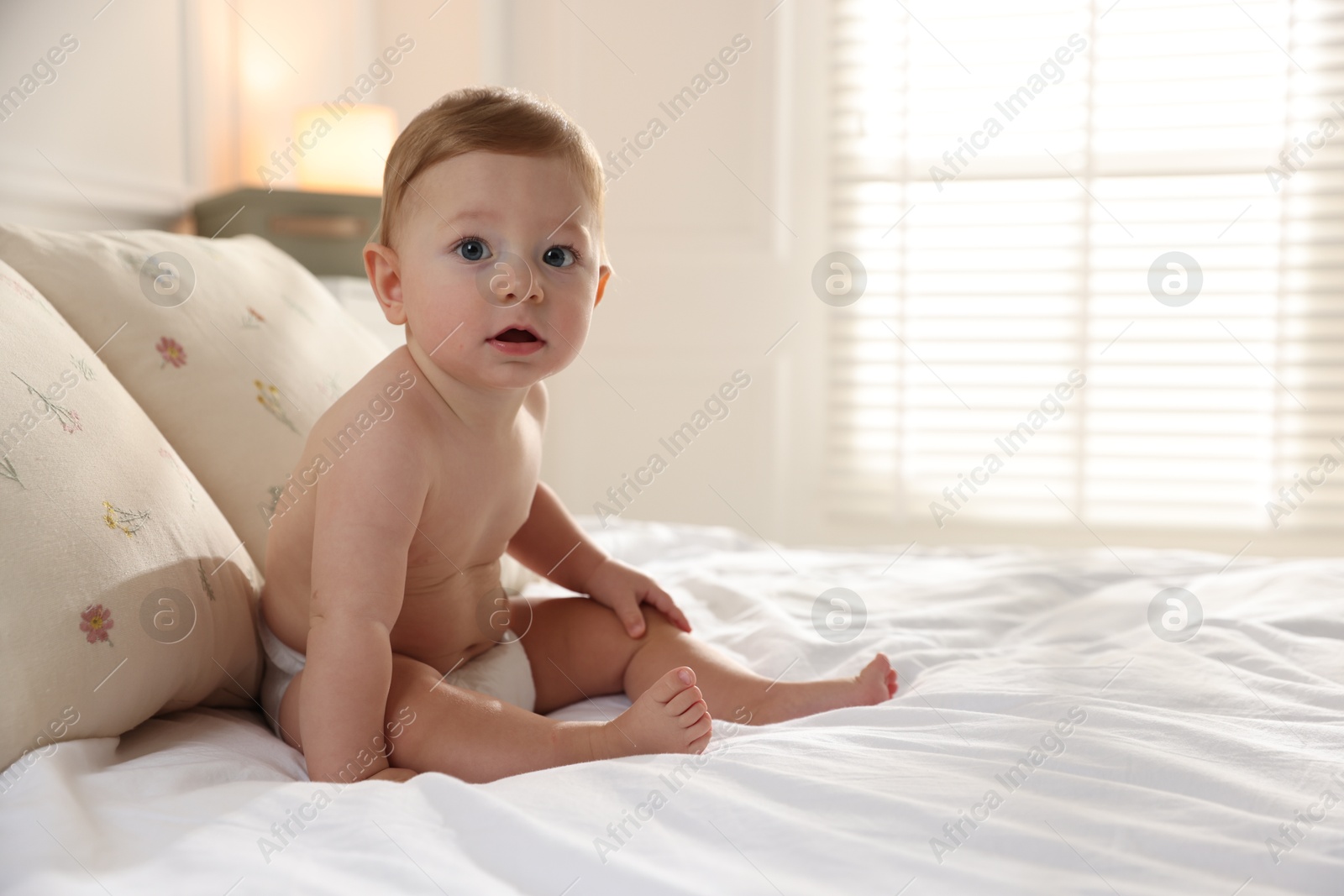 Photo of Cute little baby on bed at home