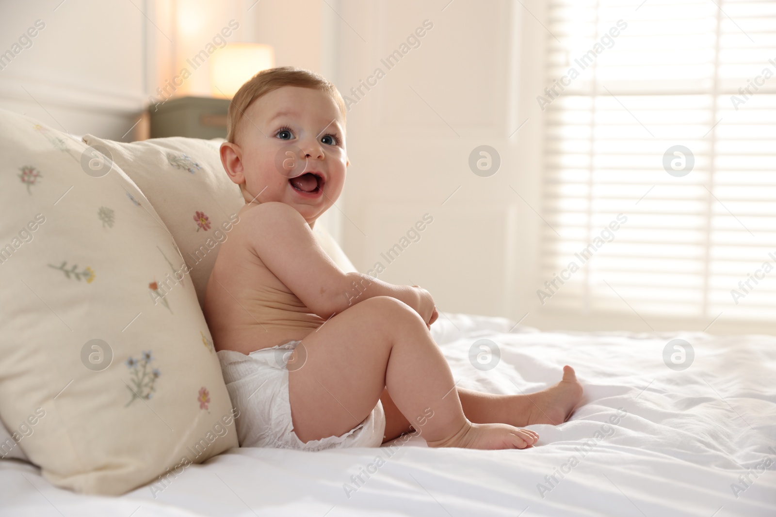 Photo of Cute little baby on bed at home