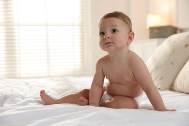 Cute little baby on bed at home