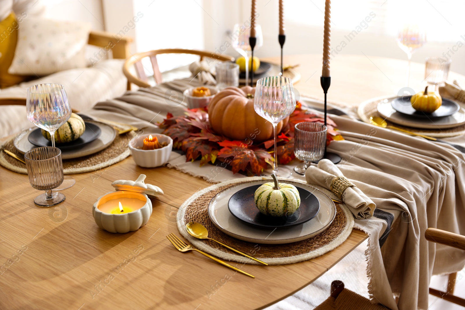 Photo of Stylish table setting with beautiful dishware and autumn decor in dining room